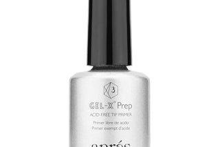 Apres Gel-X Prep bottle beside soft gel tips laid out on a nail bench