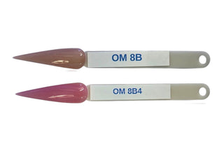 Chisel ombre dipping powder jars on a nail bench with a swatched fade running pink into white