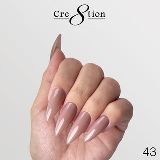 A hand wearing Cre8tion brush-on builder 43 Mauve Cashmere Wrap, a soft mauve nude