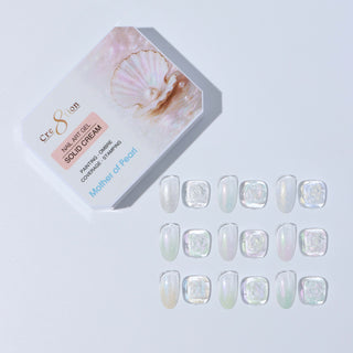 Cre8tion Mother of Pearl palette lid beside twelve clear swatch tips in a soft pearl finish