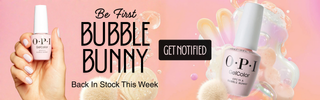 OpI nail polish bottles with a hand holding one, on a pink background with 'Bubble Bunny' text. We saw you layering "Funny Bunny®" over "Bubble Bath®" for the perfect milky pink, so we bottled the magic–no mixing required. Sheer, airy, and instantly an iconic gel nail polish.
