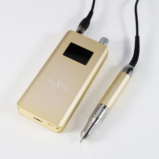 Light yellow Cre8tion cordless e-file handpiece and control unit on a pale gray surface