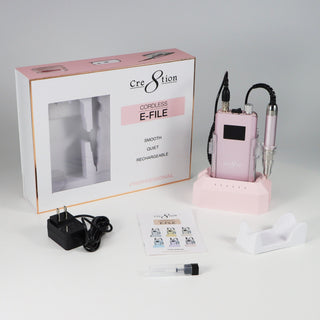 Pink blossom Cre8tion cordless e-file in its window box with charger, bits and a white cradle