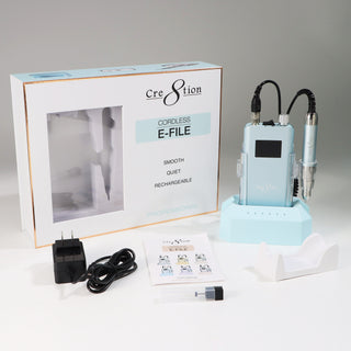 Sky blue Cre8tion cordless e-file in its window box with charger, bits and a white cradle