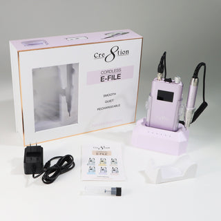 Soft violet Cre8tion cordless e-file in its window box with charger, bits and a white cradle