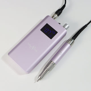 Soft violet Cre8tion cordless e-file handpiece and control unit on a pale gray surface